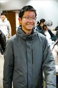 A person walking into a classroom.
